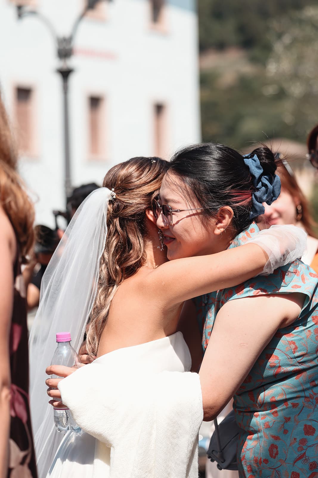 Bride embraced by a friend after the ceremony
